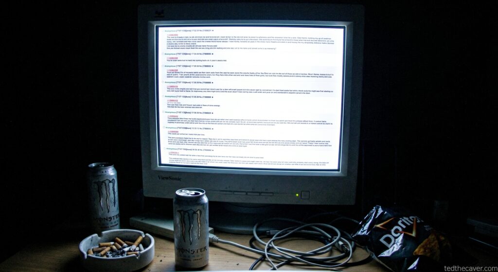 An old CRT monitor in a dark room with energy drinks and tortilla chips.